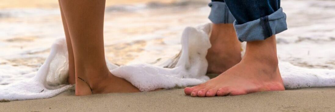 Picture of Barefooted Couple standing in the water at the beach